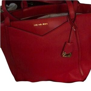 Micheal Kors large red leather bag   outside pockets, handles & crossbody strap